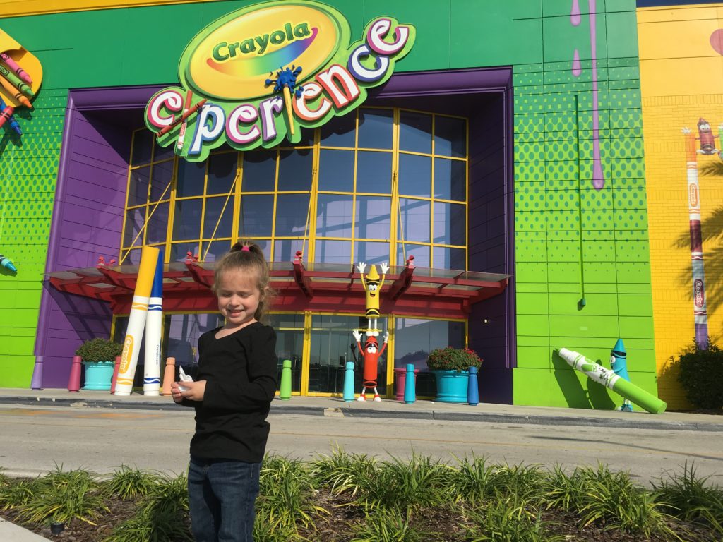 Kindergartner standing in front of The Crayola Experience Orlando