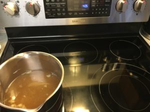 homemade chicken broth coming to boil for chicken and yellow rice dinner