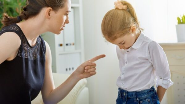 mother with authoritarian parenting style scolding her child