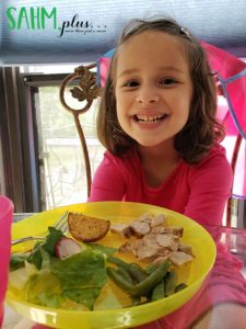 Child smiling about her meal made from PlateJoy menu plan | sahmplus.com