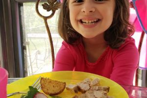 Child smiling about her meal made from PlateJoy menu plan | sahmplus.com