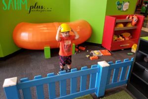 Toddler boy imaginary play in hard hat at Glazer Children's Museum | sahmplus.com