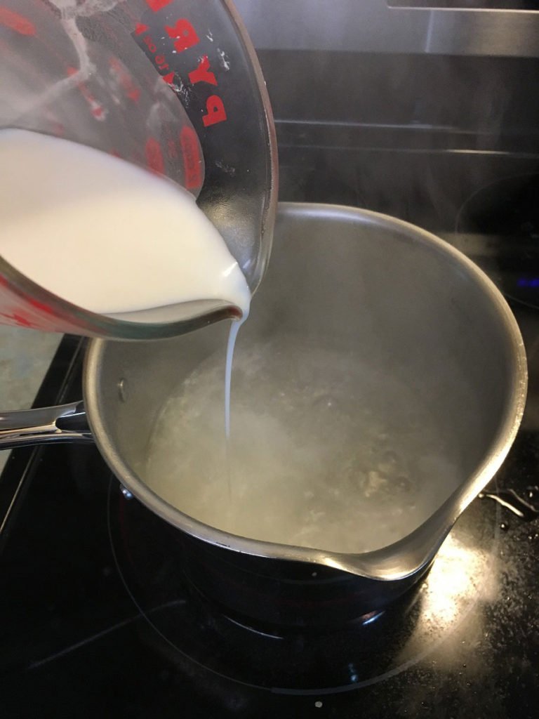 Mixing cornstarch with boiling water for toddler squishy bag