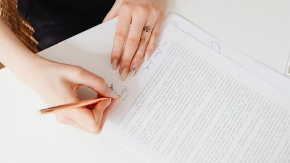 woman's hands signing a will