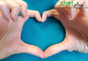 hands making the shape of a heart to celebrate American Heart Month