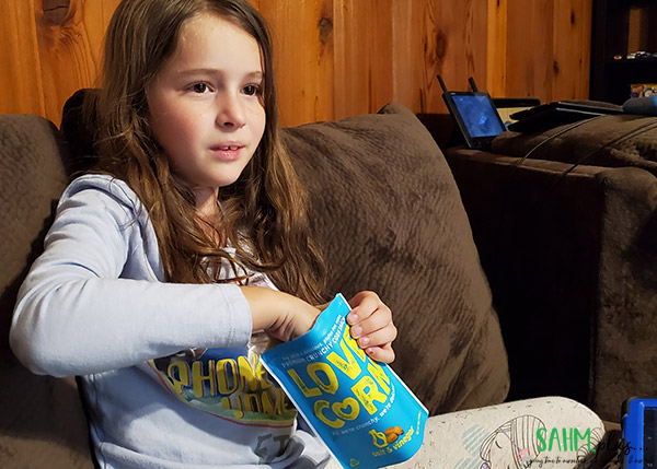 girl eating salt vinegar love corn snacks after school