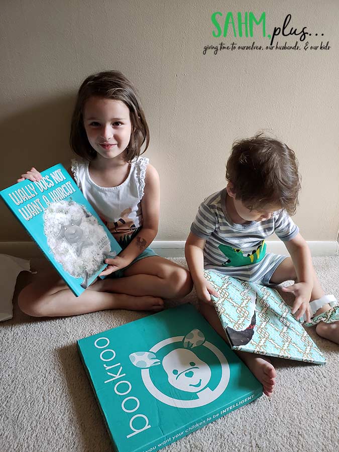 Kids opening Bookroo - monthly book subscription box | sahmplus.com