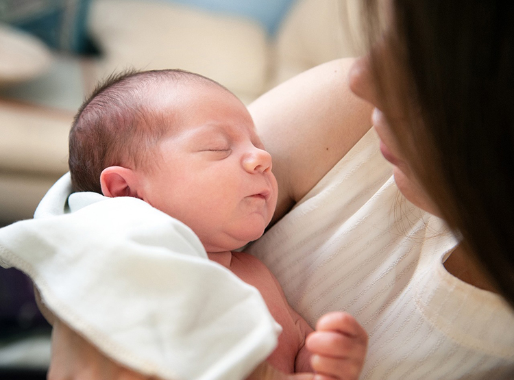 mom with newborn baby in arms