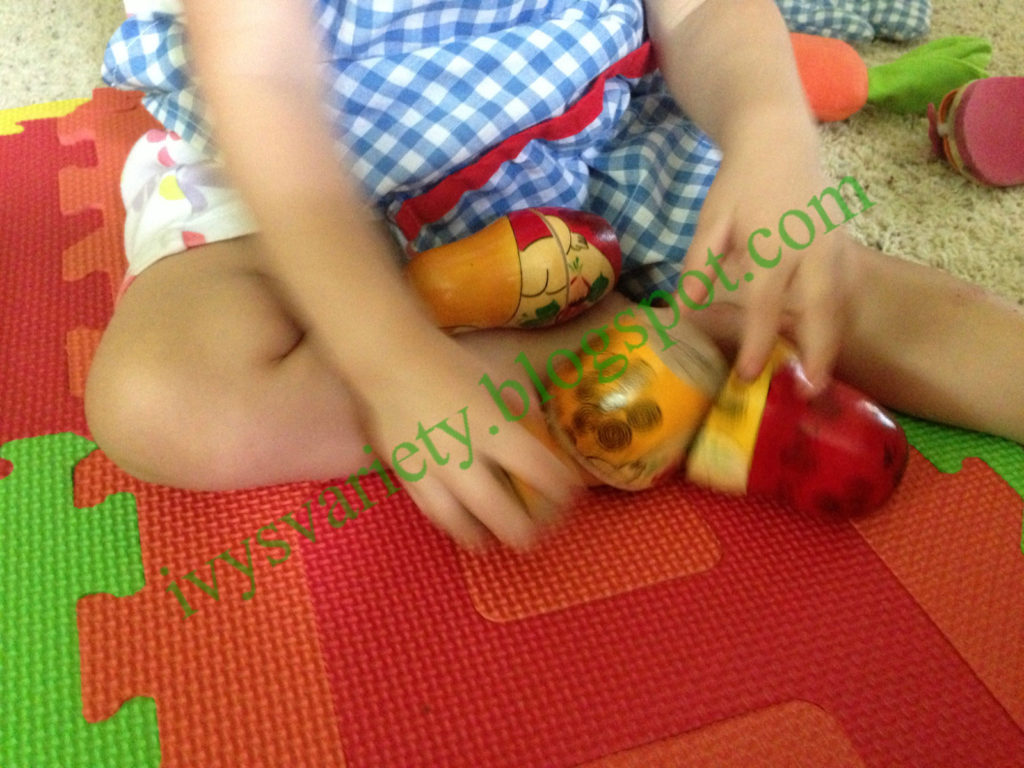 toddler plays with wooden nesting dolls | www.sahmplus.com