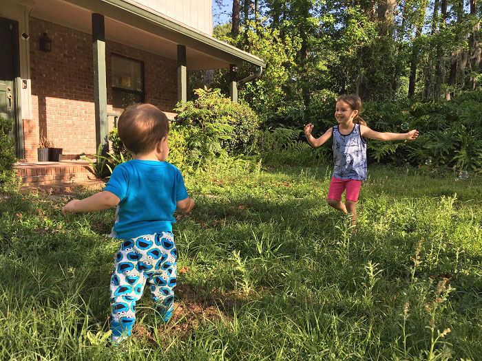 Kids chasing bubbles in the yard, summer | www.sahmplus.com