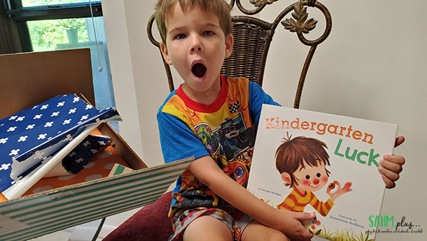 child surprised by new books from BookRoo, getting benefits of reading delivered to home