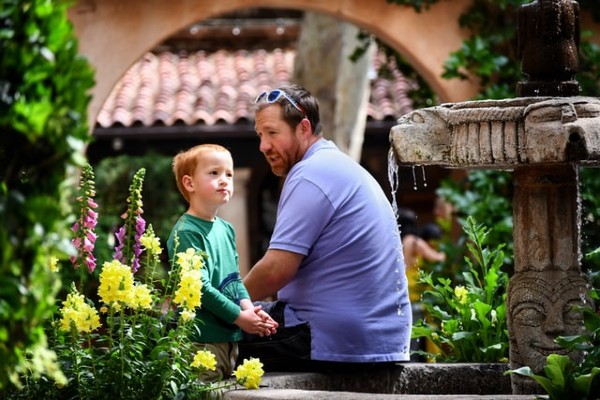 father talking to son at fountain - the importance of discipline