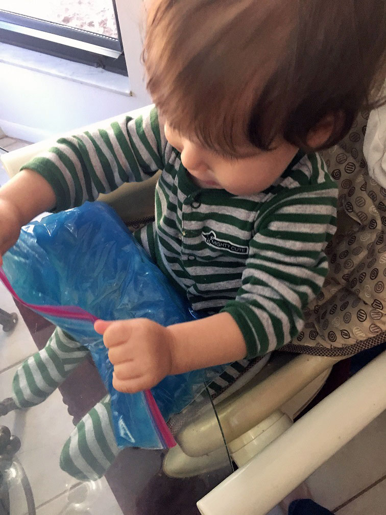 Toddler playing with his new toddler squishy bag