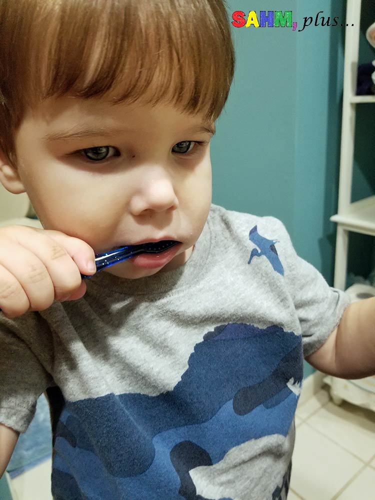 Toddler brushing teeth. One way to promote toddler independence is to allow them to take part in their own personal hygiene. | www.sahmplus.com