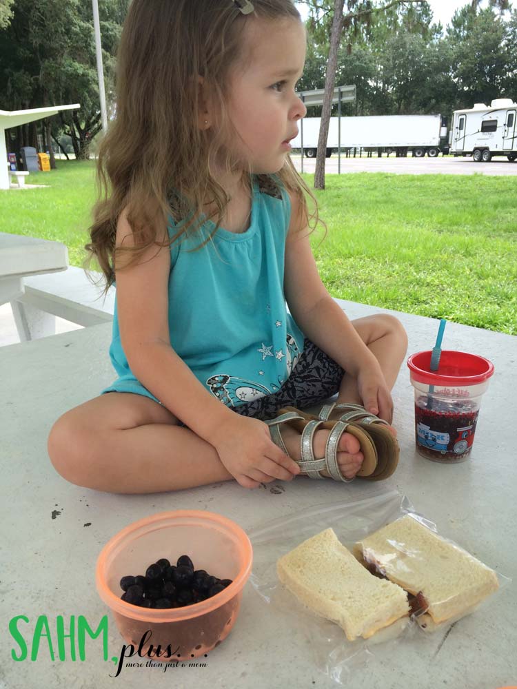 toddler having lunch at a rest stop on the way to The Florida Aquarium