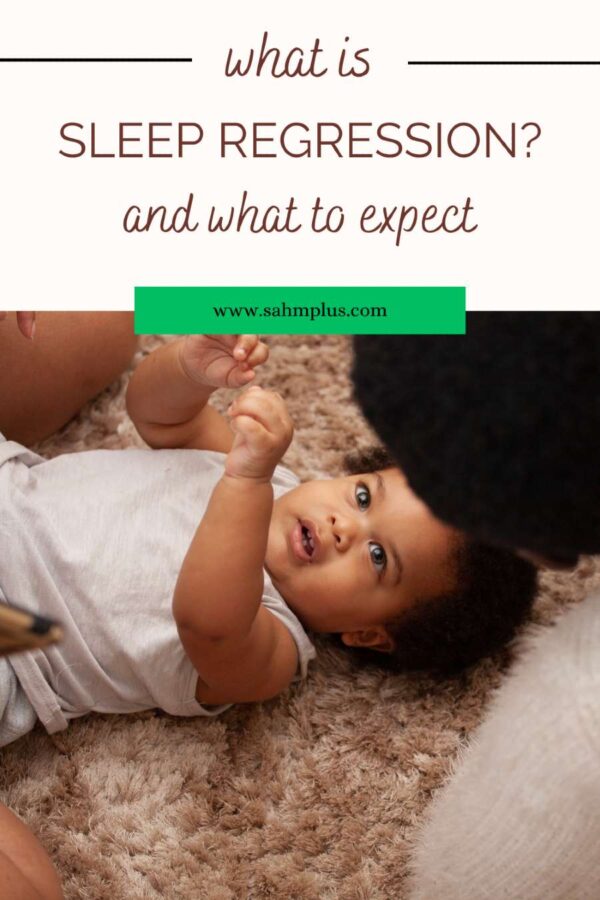 mom hovering over baby laying on floor for article what is sleep regression